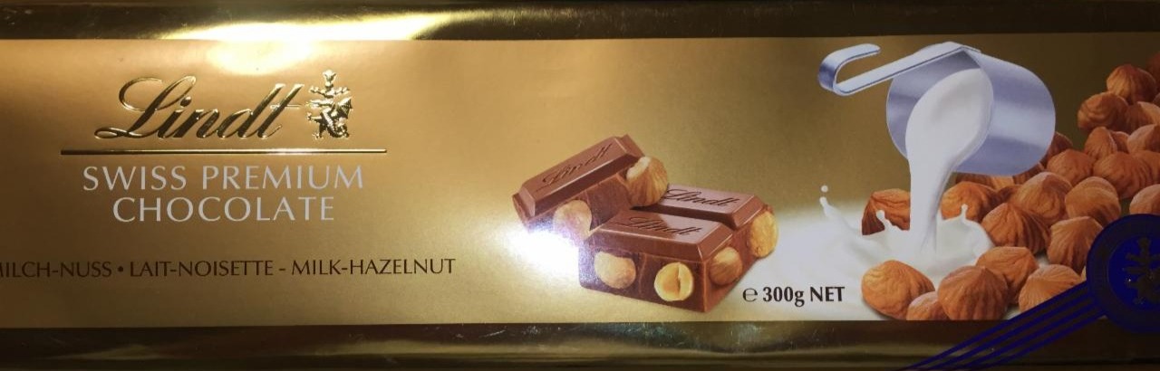 Zdjęcia - Szwajcarska czekolada mleczna z całymi orzechami laskowymi Lindt