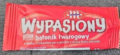 Zdjęcia - Wypasiony batonik twarogowy o smaku truskawkowym w polewie o smaku białej czekolady Mlekovita